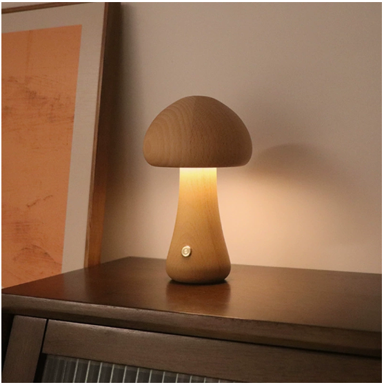Modern mushroom table lamp with warm LED ambient lighting on a bedside table