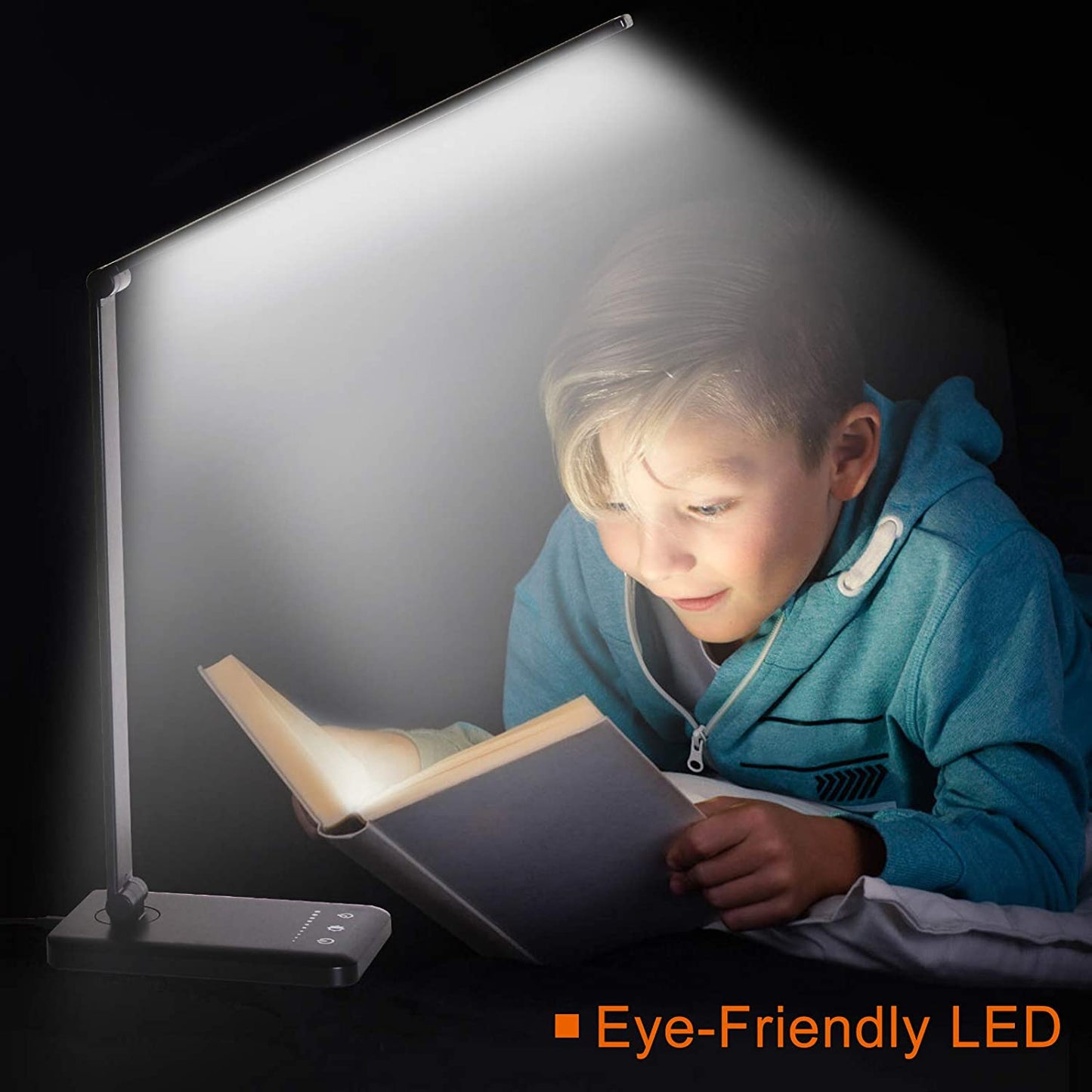 Modern LED desk lamp with wireless phone charger illuminating a minimalist office desk