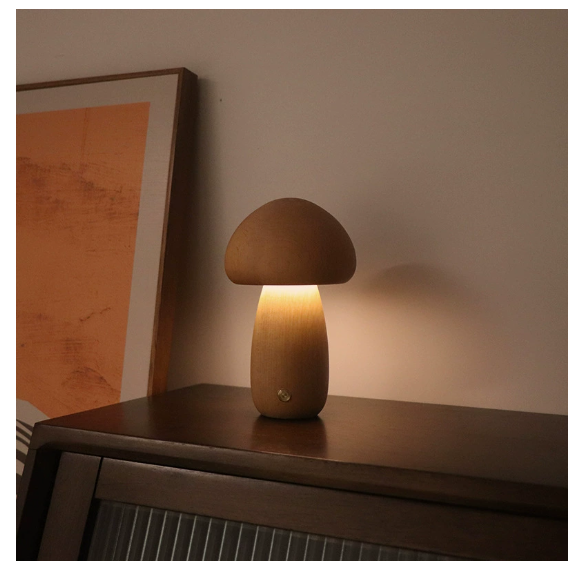 Modern mushroom table lamp with warm LED ambient lighting on a bedside table
