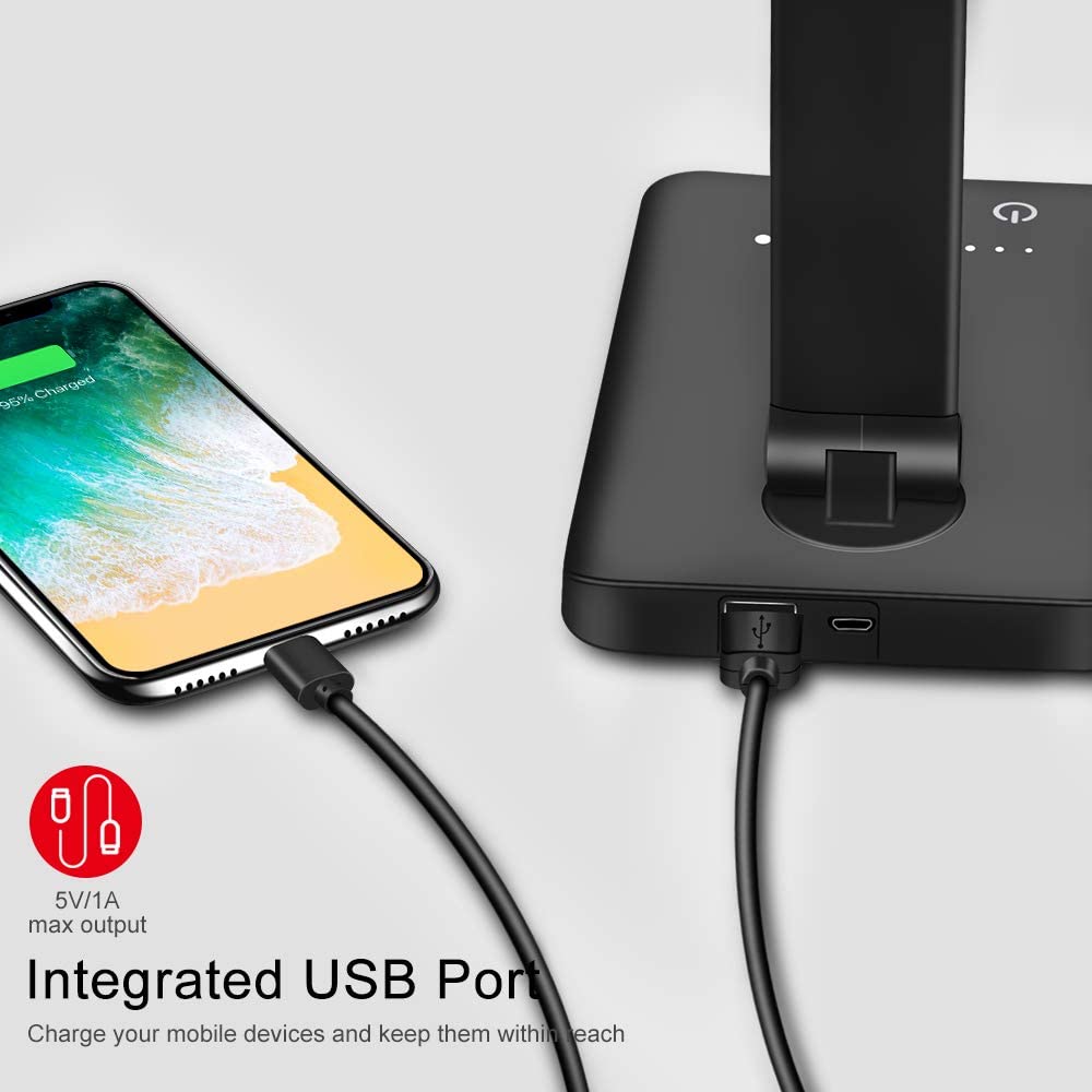 Modern LED desk lamp with wireless phone charger illuminating a minimalist office desk