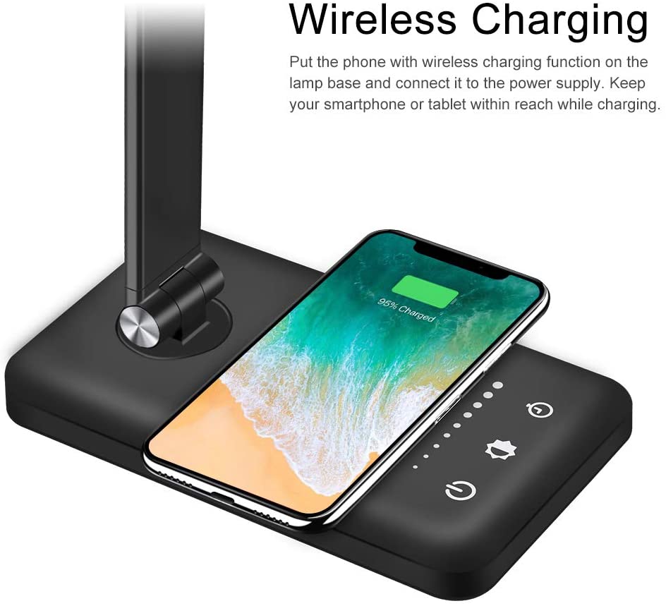 Modern LED desk lamp with wireless phone charger illuminating a minimalist office desk