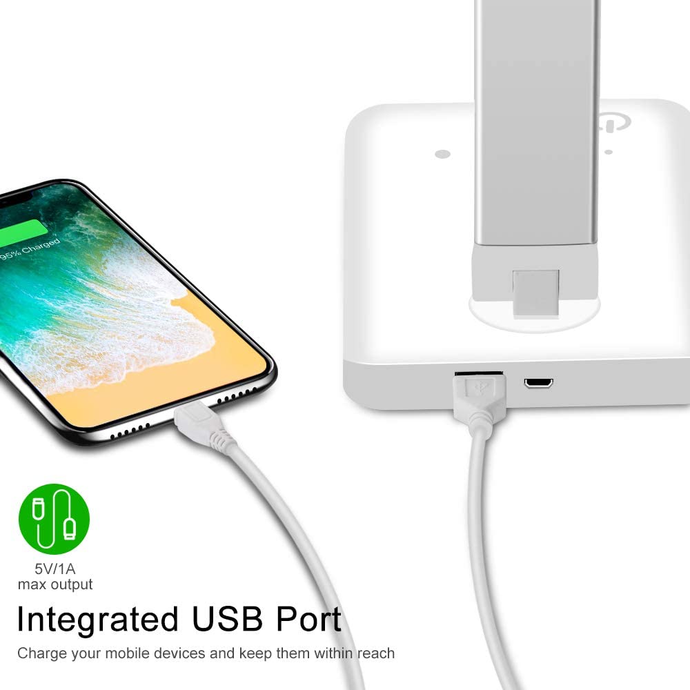 Modern LED desk lamp with wireless phone charger illuminating a minimalist office desk