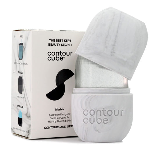 Woman using Contour Cube Original Ice Roller for facial sculpting and de-puffing skincare routine