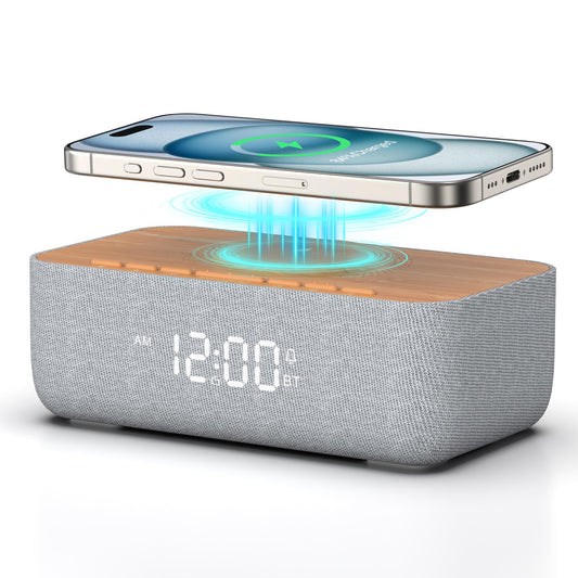 REACHER alarm clock radio with magnetic wireless charger charging an iPhone on a modern bedside table