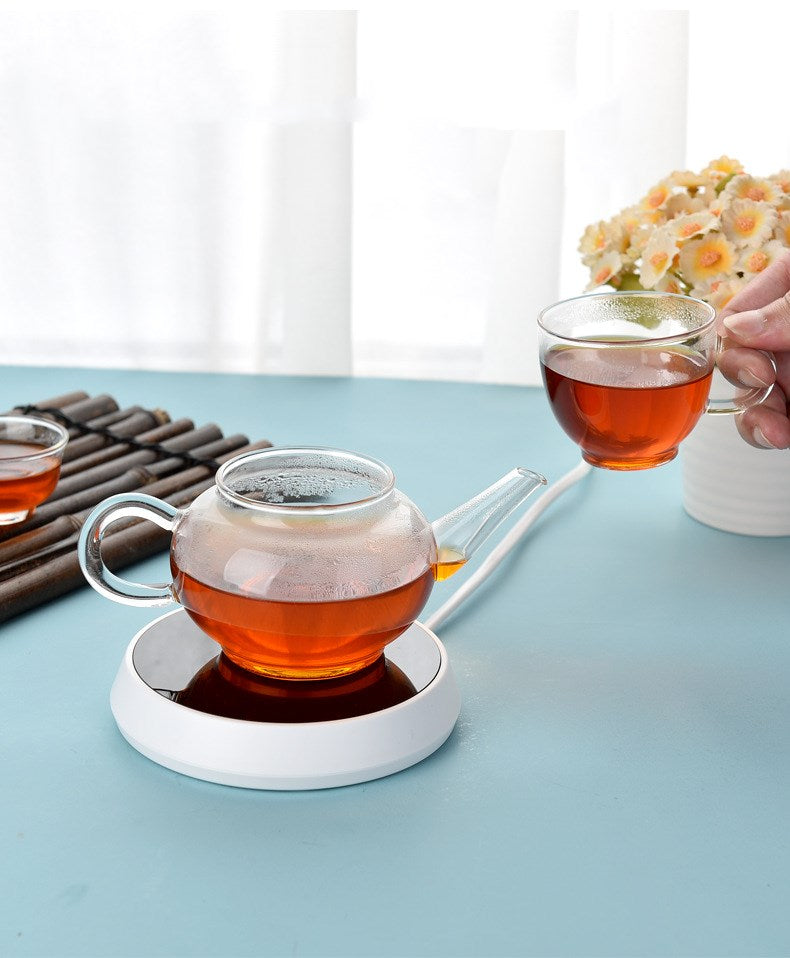 Smart coffee mug warmer keeping a ceramic coffee cup at the perfect drinking temperature on an office desk