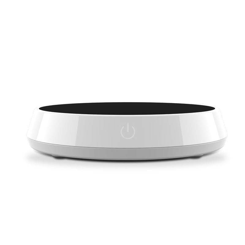 Smart coffee mug warmer keeping a ceramic coffee cup at the perfect drinking temperature on an office desk