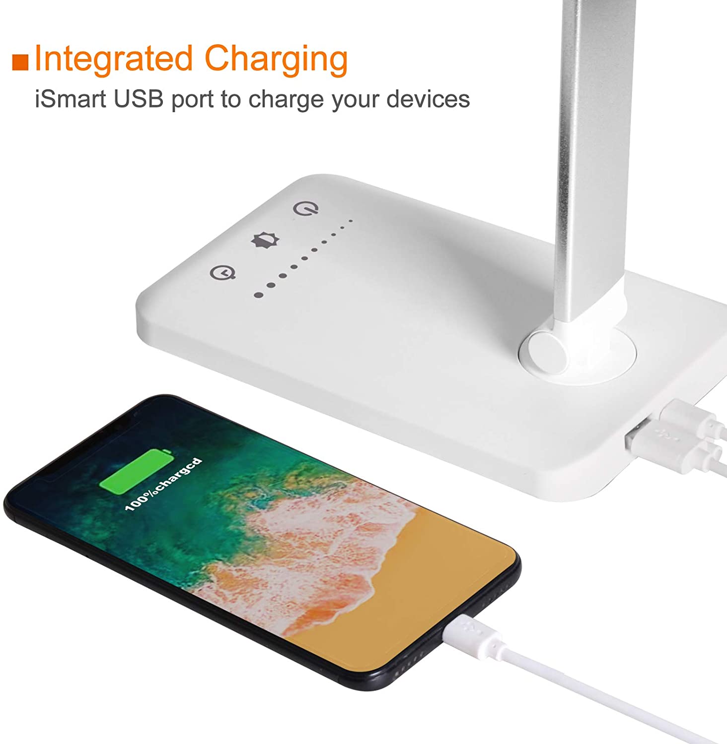 Modern LED desk lamp with wireless phone charger illuminating a minimalist office desk