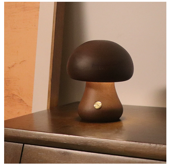 Modern mushroom table lamp with warm LED ambient lighting on a bedside table