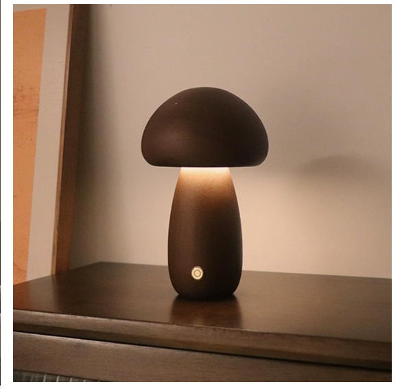 Modern mushroom table lamp with warm LED ambient lighting on a bedside table