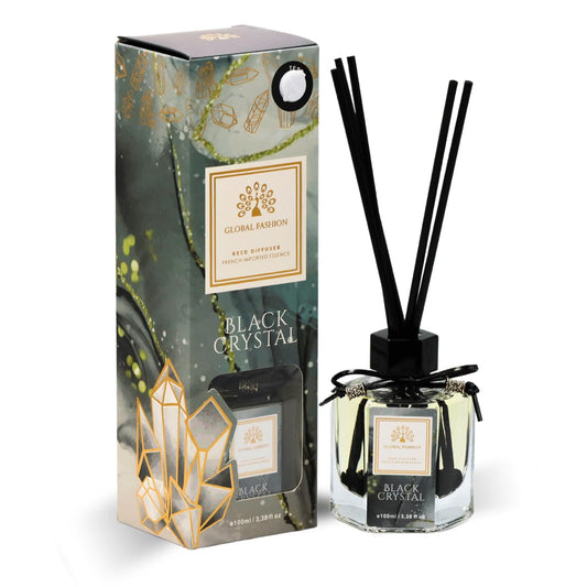 Global Fashion 100ml reed diffuser with natural rattan sticks displayed on a modern wooden table