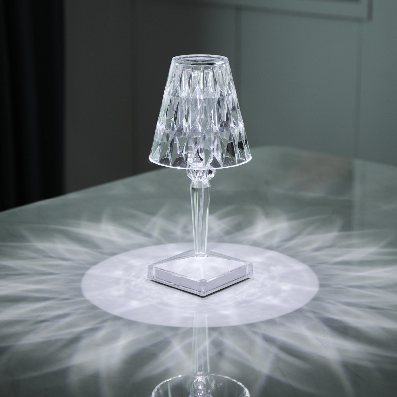 Rechargeable portable LED atmosphere lamp providing warm ambient lighting on a modern bedside table